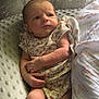 arms, baby, blanket, cozy, cute, expression, face, floral_onesie, hand, indoor, infant, legs, natural_light, newborn, person, pillow, resting, serious, skin, soft_texture