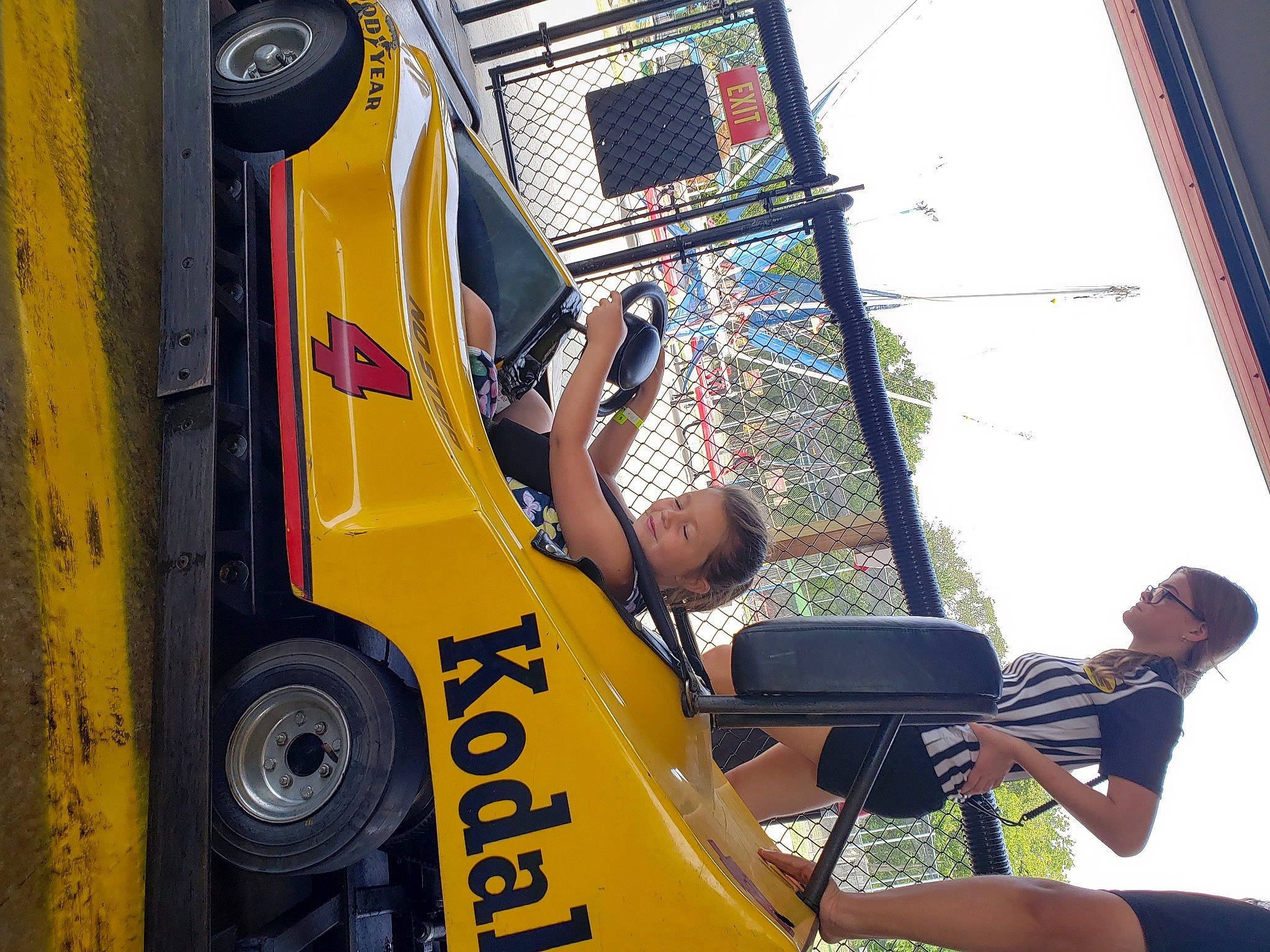 Maelynn is registered to the contest to win money with this photo: arm, asphalt, automotive_design, automotive_exterior, automotive_tire, automotive_wheel_system, commercial_vehicle, engineering, fun, hand, joy, mode_of_transport, motor_vehicle, person, shorts, sky, t_shirt, tire, travel, vehicle