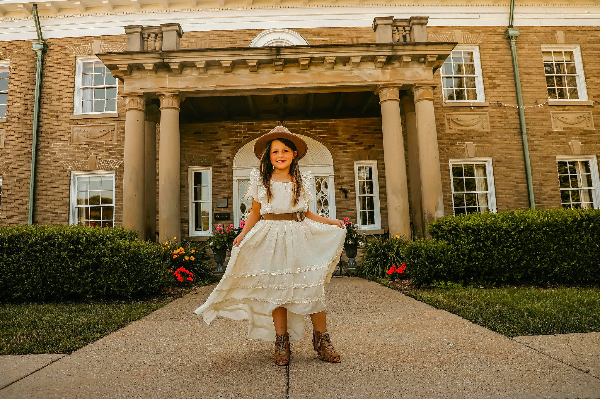 Maelynn joined the competition — help win amazing prizes! bridal_clothing, brown_hair, building, dress, eyewear, facade, fashion_design, flower, formal_wear, gown, grass, headpiece, high_heels, house, human_leg, joy, lawn, person, plant, street_fashion