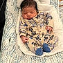 Josiah is registered to the contest to win money with this photo: baby, sleeping, onesie, animal_print, baby_lounger, infant, cute, cozy, patterned, clothing, footwear, soft, rest, peaceful, indoor, newborn, child, portrait, comfort, relaxation