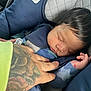 Josiah joined the competition — help win amazing prizes! baby, sleeping, car_seat, tattoo, hand, clothing, infant, peaceful, child, portrait, closeup, safety, seatbelt, nap, comfort, indoors, person, skin, hair, babywearing