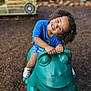 Samaria is registered to the contest to win money with this photo: child, curly_hair, smiling, playground, green_frog, play_toy, blue_shirt, white_shoes, outdoor, park, happy, play, fun, kid, summer, daylight, leisure, recreation, young, person