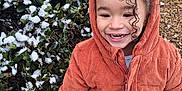 Samaria joined the competition — help win amazing prizes! child, smiling, hood, corduroy_jacket, outdoor, winter, snow, bush, rocks, happy, curly_hair, face, person, nature, cold_weather, jackets, footwear, daylight, cheerful, portrait