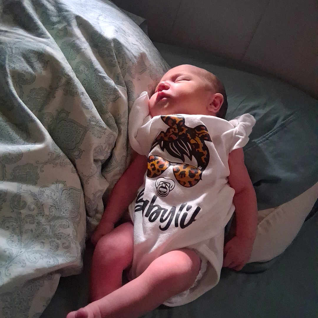 Connie Sage joined the competition — help win amazing prizes! baby, bed, blanket, child, clothing, cute, human, indoors, infant, lying_down, newborn, onesie, pattern, peaceful, pillow, rest, skin, sleeping, small, soft_light