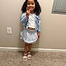 Makiah joined the competition — help win amazing prizes! carpet, casual, child, curly_hair, cute, fashion, girl, happy, indoor, jacket, light_skin, outfit, peace_sign, person, pose, sandals, skirt, smiling, standing, wall
