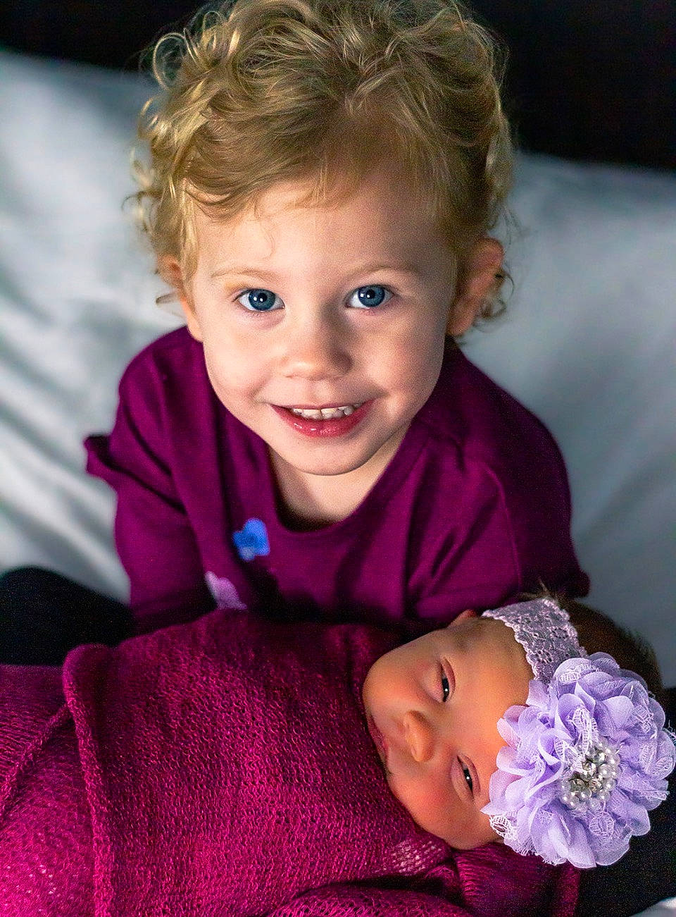 Ella is registered to the contest to win money with this photo: baby, baby_products, baby_toddler_clothing, beauty, cheek, child, comfort, fashion_accessory, fun, happy, iris, joy, laugh, magenta, person, pink, purple, sitting, skin, smile