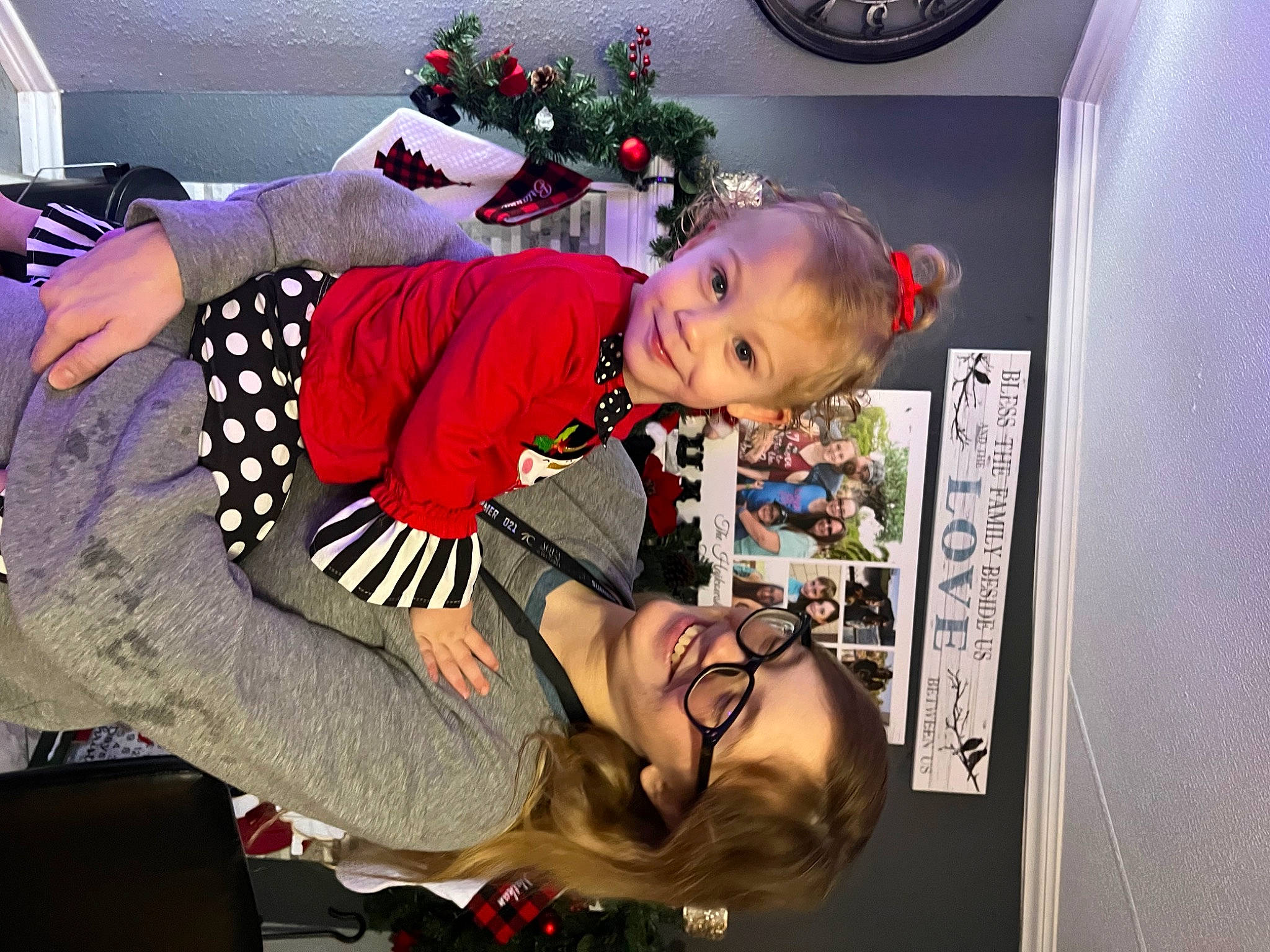 Ella is registered to the contest to win money with this photo: arm, baby, blurred, child, christmas, christmas_decoration, christmas_ornament, christmas_tree, event, fun, happy, holiday, holiday_ornament, interior_design, joy, lap, ornament, person, room, smile