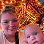 Taylor is registered to the contest to win money with this photo: amusement_ride, baby, blond_hair, blue_eyes, carousel, child, clothing, decor, entertainment, event, face, fun, happy, indoor, lights, person, portrait, selfie, smile, woman