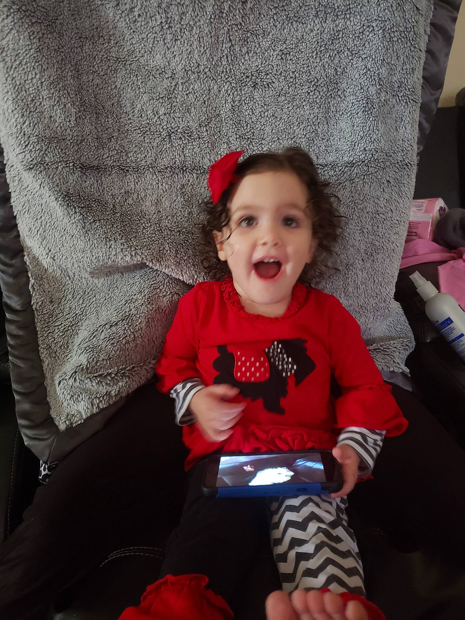 Layanna joined the competition — help win amazing prizes! baby, child, christmas, eye, facial_expression, family, fun, head, holiday, laugh, leg, people, person, play, red, sitting, skin, smile, surprise, t_shirt