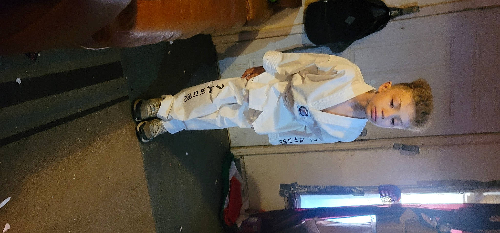 Colin is registered to the contest to win money with this photo: dobok, flooring, fun, human_leg, karate, machine, person, room, uniform