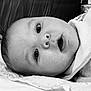 baby, infant, face, closeup, black_and_white, lying_down, soft_cloth, expression, wide_eyes, mouth_open, skin, head, person, newborn, cute, portrait, young, indoors, blanket, resting