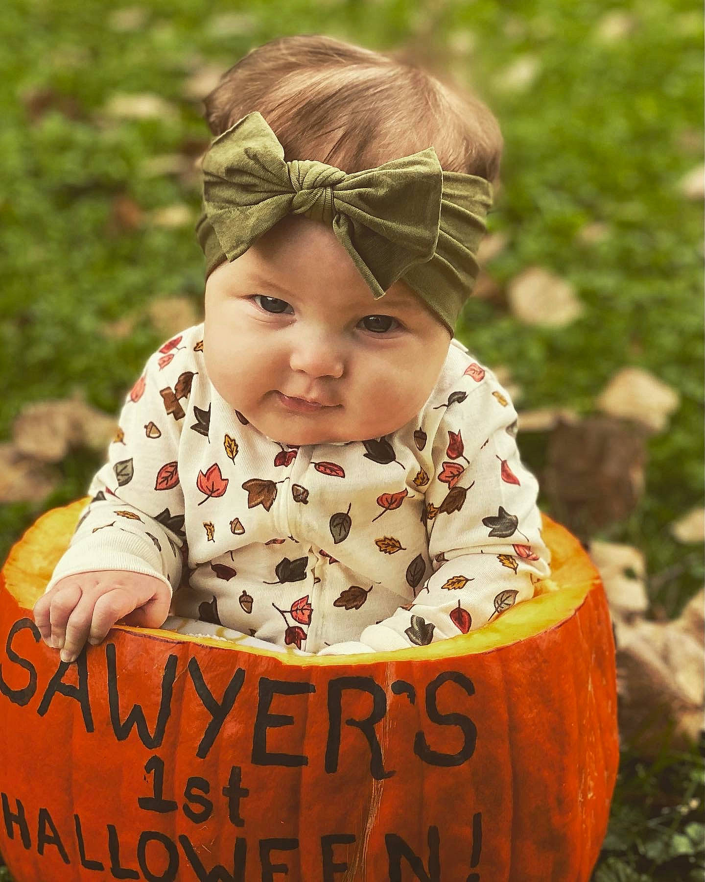 Sawyer is registered to the contest to win money with this photo: baby_toddler_clothing, cap, child, clothing, eye, face, facial_expression, grass, happy, head, headgear, headpiece, headwear, leaf, pattern, people_in_nature, person, photograph, plant, sleeve