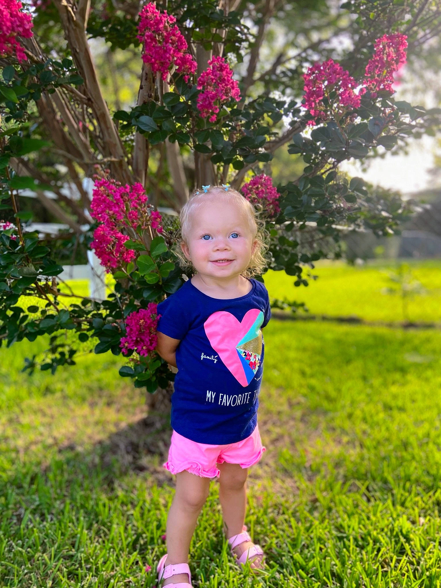 Amalie is registered to the contest to win money with this photo: baby, baby_toddler_clothing, beauty, botany, child, electric_blue, flower, fun, grass, happy, joy, leaf, leisure, magenta, people_in_nature, person, pink, plant, shorts, summer