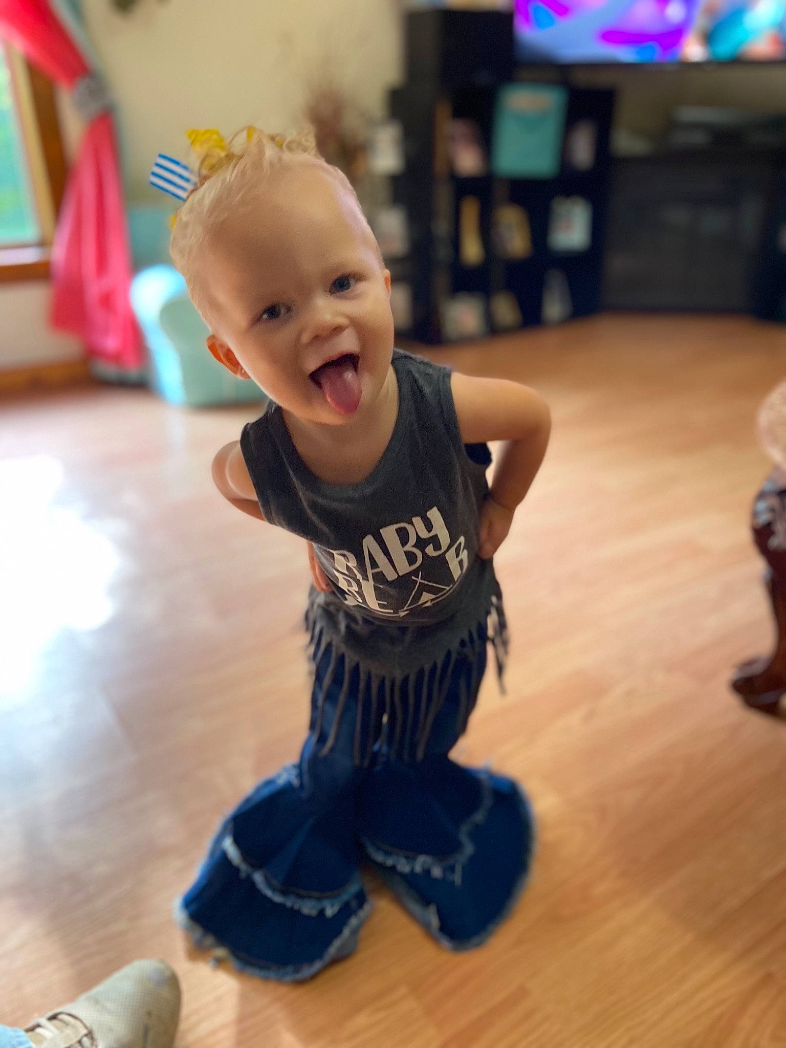 Amalie is registered to the contest to win money with this photo: baby, baby_toddler_clothing, clothing, facial_expression, floor, flooring, fun, happy, hardwood, joint, laminate_flooring, leg, person, shoulder, skin, sleeve, smile, sportswear, standing, toddler