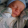 Leland Matthew is registered to the contest to win money with this photo: baby, newborn, infant, sleeping, portrait, closeup, face, beanie, hat, swaddle, blanket, patterned_fabric, cheeks, peaceful, cute, pacifier_clip, tiny_hands, skin, mouth, soft_lighting