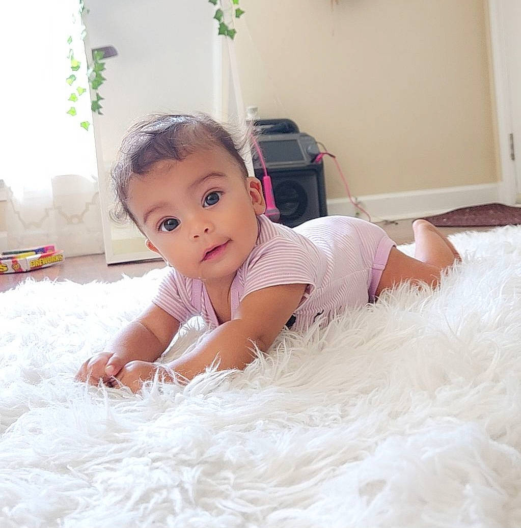 Alora joined the competition — help win amazing prizes! abdomen, baby, baby_toddler_clothing, bedding, child, comfort, eye, floor, flooring, fun, fur, happy, human_leg, iris, linens, person, shoulder, sitting, sleeve, surprise