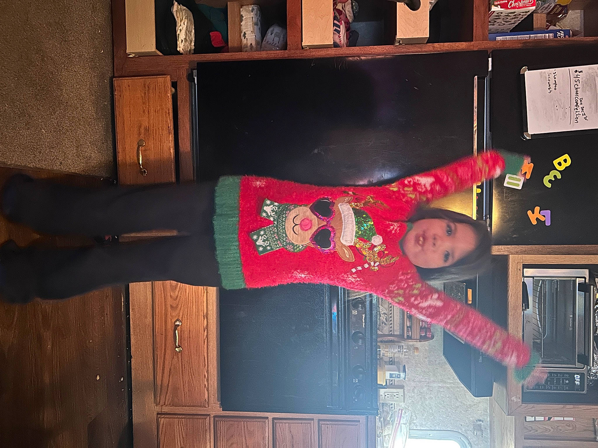 Hazel is registered to the contest to win money with this photo: bookcase, carmine, flooring, fun, hardwood, human_leg, magenta, pattern, person, room, shelf, shelving, sleeve, thigh, wood, wrist