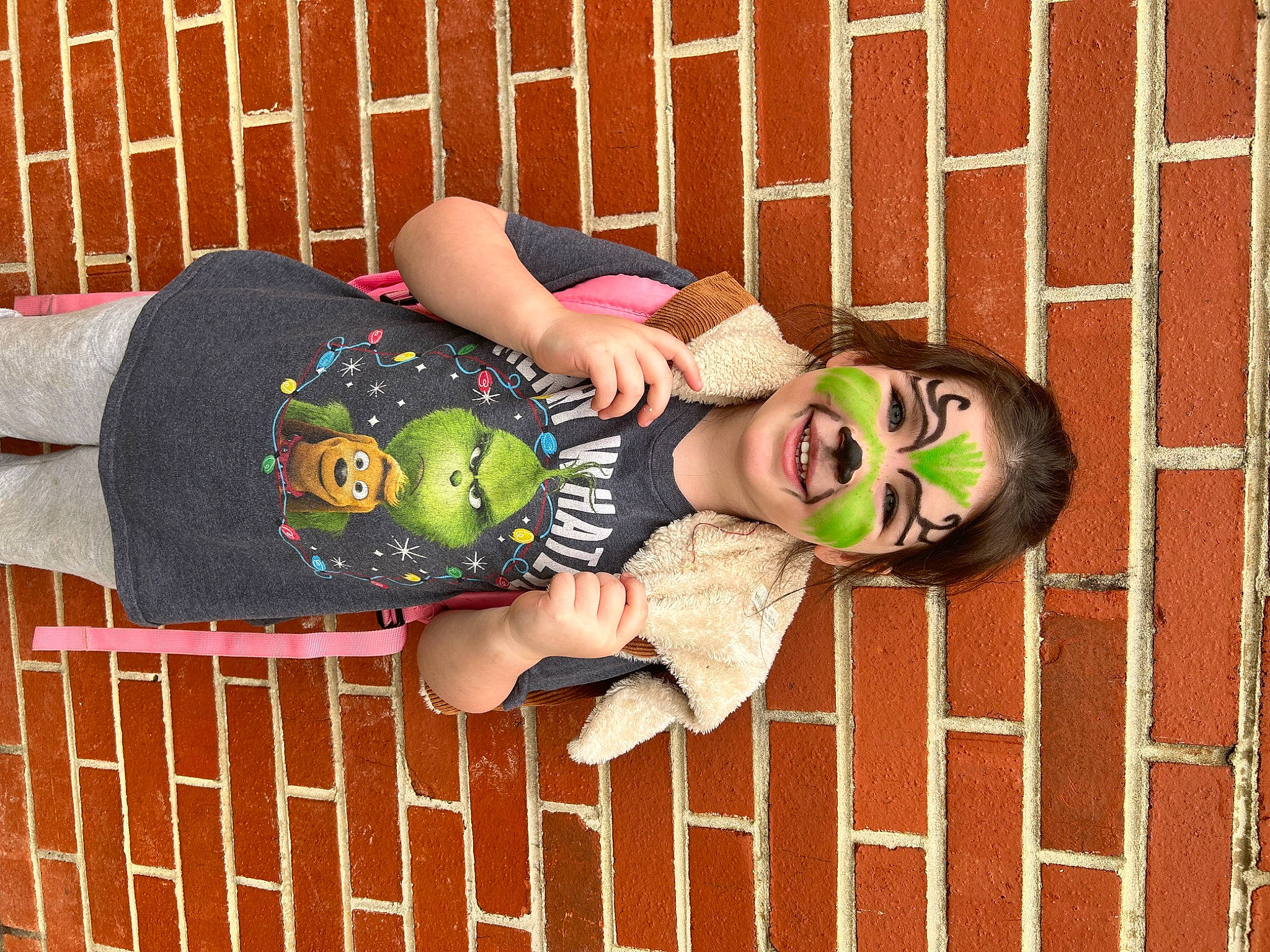 Hazel is registered to the contest to win money with this photo: arm, art, baby_toddler_clothing, brick, brickwork, child, eyewear, foot, fun, happy, headgear, human_leg, joy, leg, pattern, person, sandal, smile, sunglasses, textile