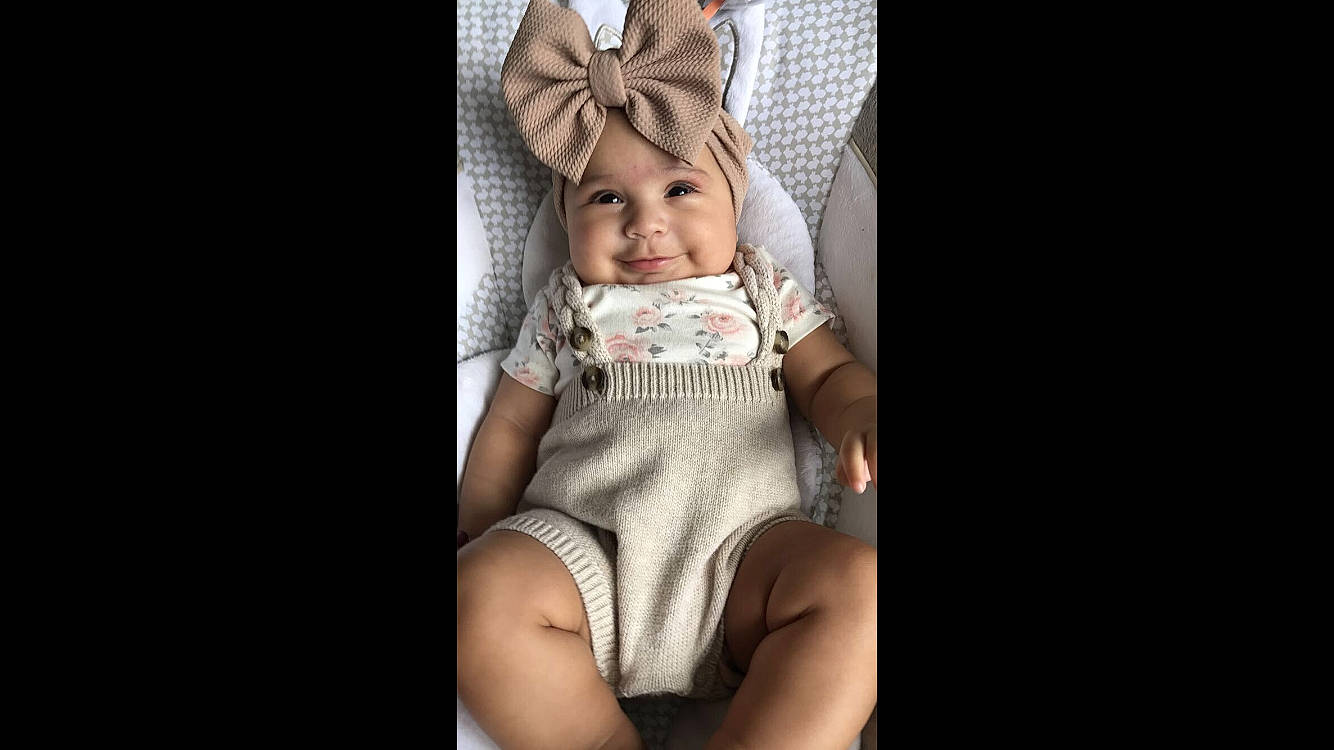 Jazlyn is registered to the contest to win money with this photo: baby, baby_products, baby_toddler_clothing, costume_accessory, embellishment, hair_accessory, headband, headpiece, headwear, joy, person