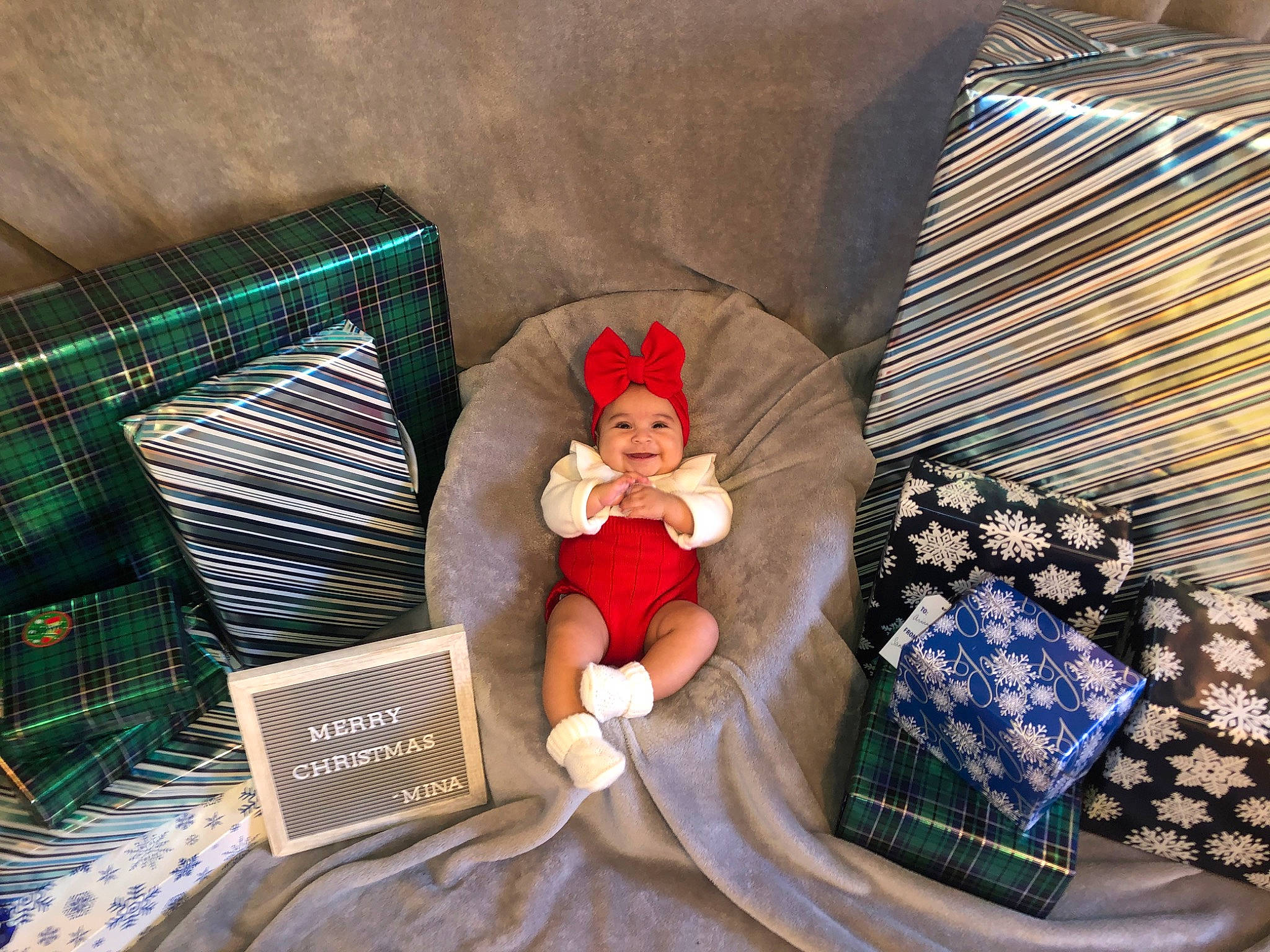 Jazlyn is registered to the contest to win money with this photo: baby, costume_accessory, costume_hat, cushion, doll, fictional_character, foot, headwear, home_accessories, human_body, joy, lap, linens, pattern, person, pillow, plaid, stuffed_toy, tartan, teddy_bear