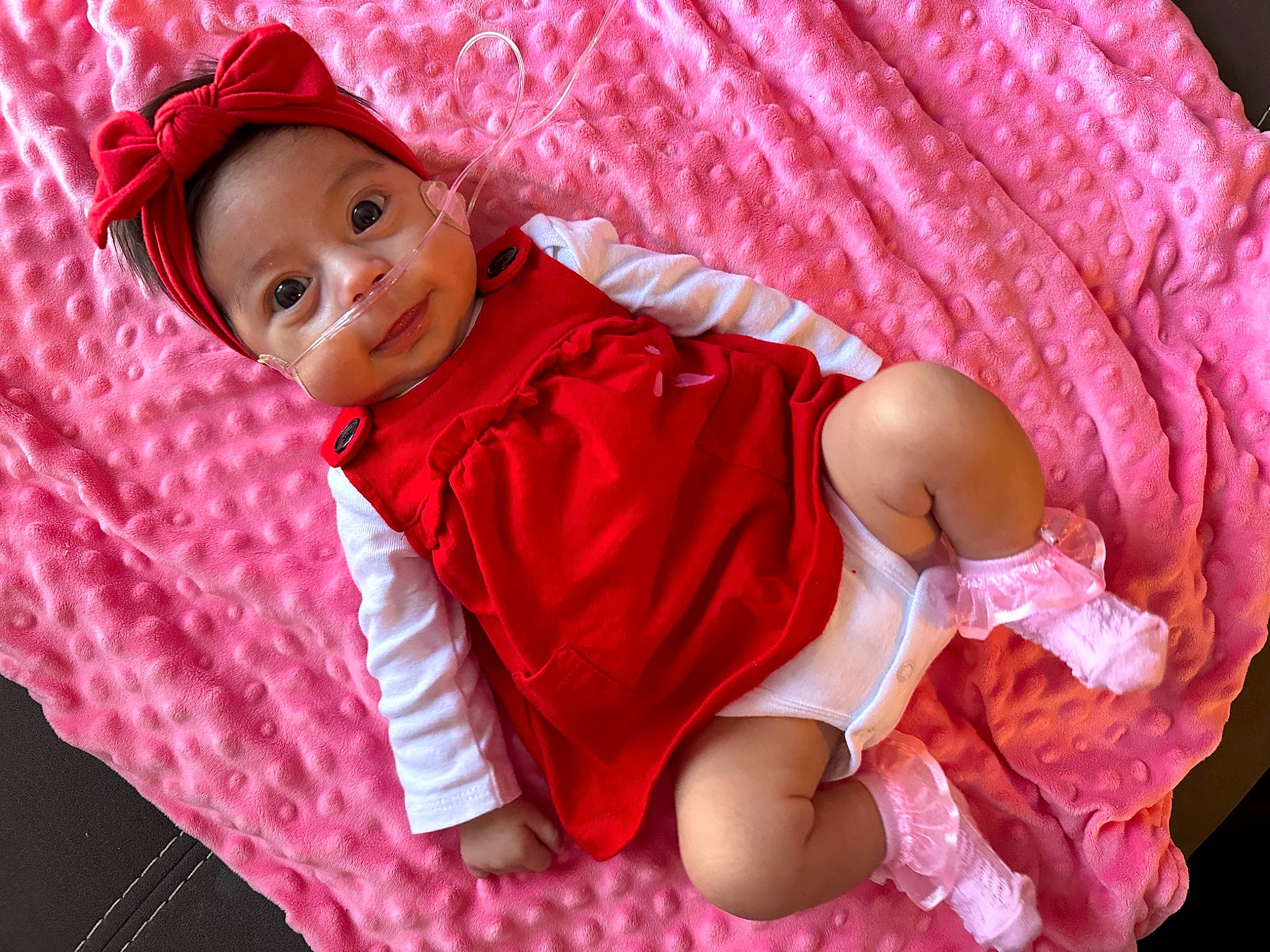 Camila joined the competition — help win amazing prizes! baby, baby_toddler_clothing, cap, comfort, happy, hat, headwear, linens, magenta, pattern, person, pink, product, purple, skin, sleeve, smile, sun_hat, textile, thigh