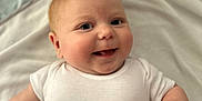 Alfie joined the competition — help win amazing prizes! adorable, baby, blanket, child, chubby, closeup, cute, cute_expression, face, happy, indoor, infant, lying_down, portrait, skin, small_hands, smile, soft, white_onesie, young