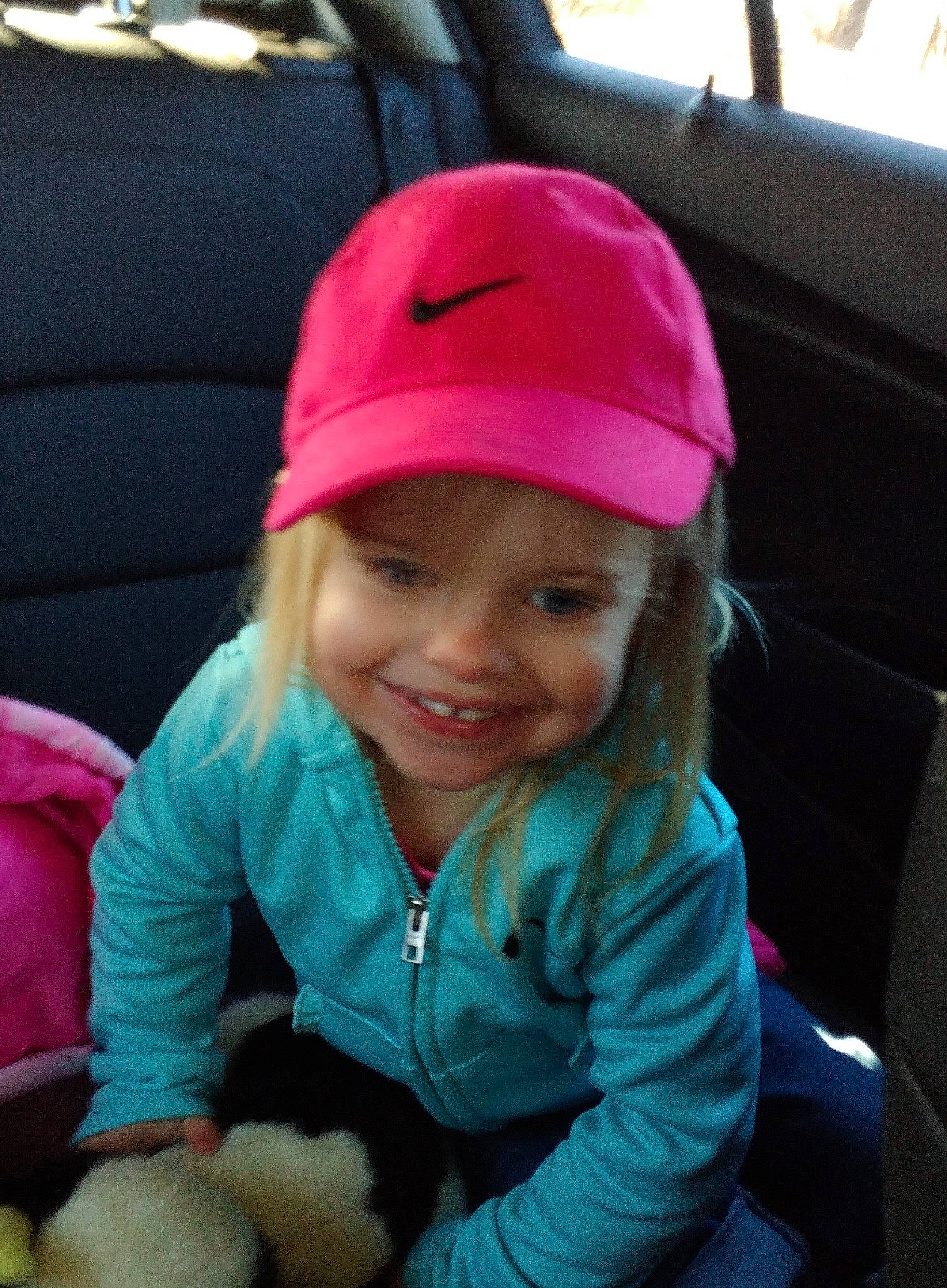 Lilly joined the competition — help win amazing prizes! auto_part, automotive_exterior, baseball_cap, cap, car_seat, child, chin, eye, happy, headwear, joy, lip, magenta, motor_vehicle, person, pink, skin, smile, snapshot, steering_wheel