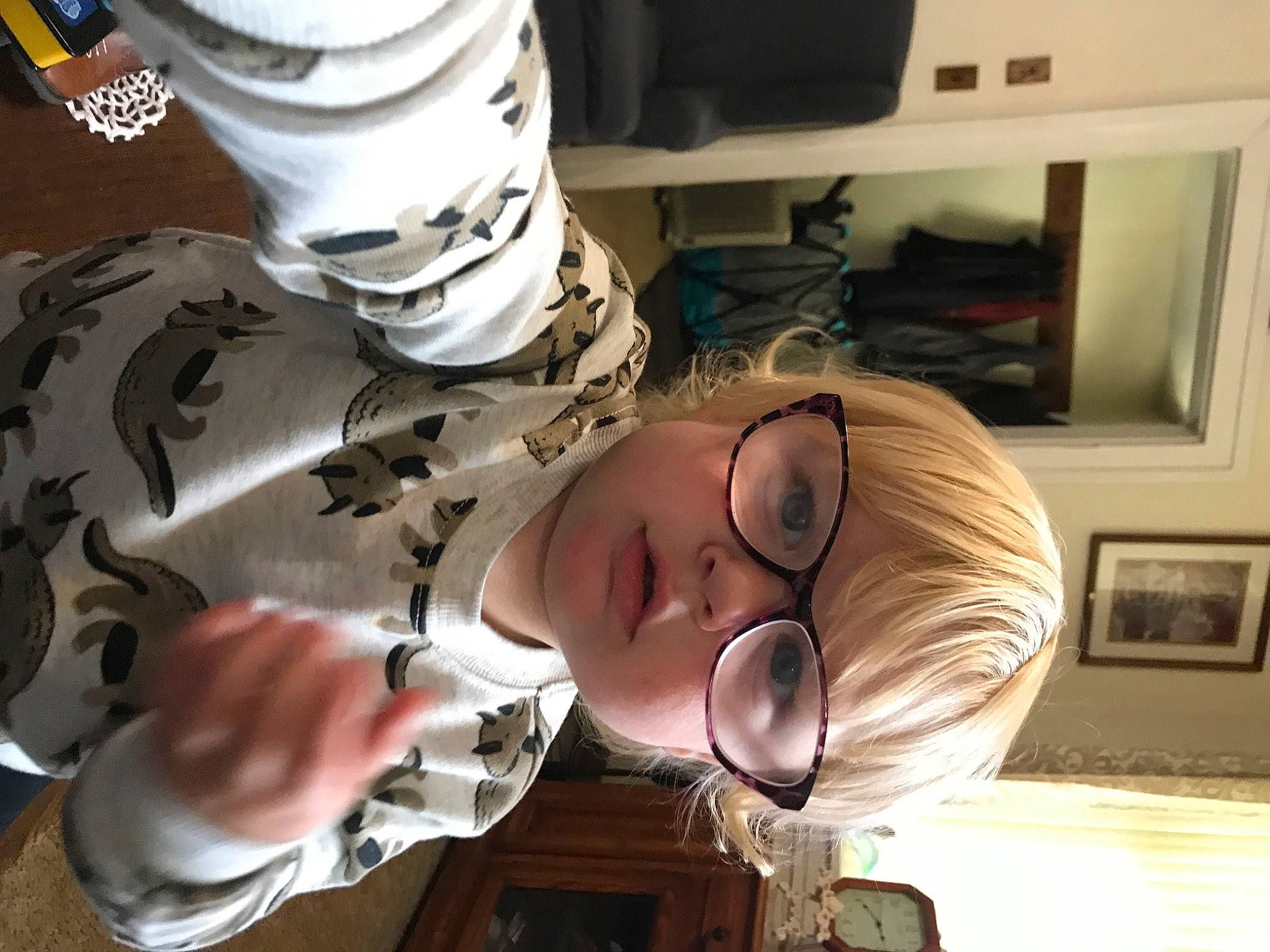 Henry is registered to the contest to win money with this photo: child, eyelash, eyewear, fun, hair_coloring, hand, hat, helmet, human_leg, machine, person, personal_protective_equipment, picture_frame, room, sports_gear, sunglasses, vision_care, wood