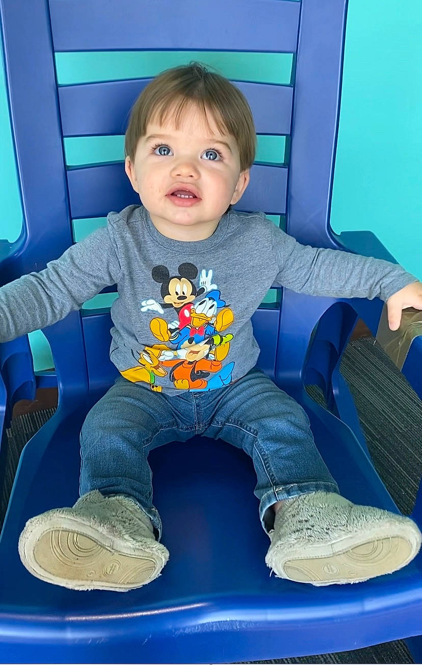 Wyatt is registered to the contest to win money with this photo: arm, baby, baby_toddler_clothing, blue, chair, cheek, comfort, eye, footwear, fun, hairstyle, leg, person, product, shoe, sleeve, smile, sneakers, standing, t_shirt