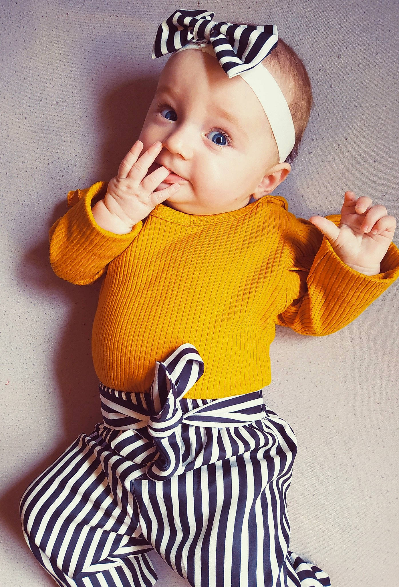 Jodie participe au concours pour gagner de l'argent avec cette photo : baby, baby_bloomers, baby_products, baby_toddler_clothing, child, child_model, costume_accessory, headgear, person, product, sleeve, toddler, yellow