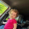 Lenni Kate joined the competition — help win amazing prizes! toddler, child, curly_hair, pink_outfit, car_interior, car_seat, window, greenery, sunlight, seatbelt, portrait, young_child, person, casual, indoor, expression, hair, seat, daylight, vehicle