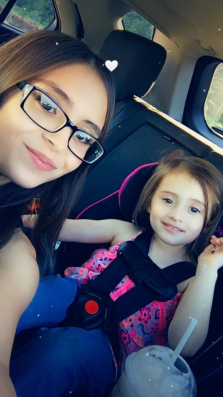 Shelby is registered to the contest to win money with this photo: automotive_design, black_hair, blue, cool, face, facial_expression, flash_photography, fun, gesture, glasses, hairstyle, happy, joy, person, photograph, purple, skin, smile, steering_wheel, vehicle_door