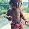 baby, child, curious, cute, daylight, diaper, expression, glasses, human, nature, outdoor_view, person, pink_diaper, portrait, road, small_child, standing, toddler, trees, window