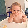 baby, child, toddler, high_chair, food, messy, eating, indoor, happy, smiling, face, skin, hair, hand, table, room, furniture, light, person, cute
