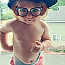 baby, blond_hair, cap, casual, child, curious, cute, daylight, diaper, funny_glasses, glasses, mischievous, outdoor, playful, portrait, skin, standing, toddler, window, young_child