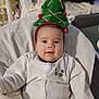 Jalil a rejoint le concours — aidez-le/la à gagner de superbes lots ! baby, child, christmas_tree_headband, festive, holiday, onesie, panda_design, plush_toy, snowman, soft_blanket, smiling, indoors, cute, headwear, happy, seated, infant, cozy, decor, celebration