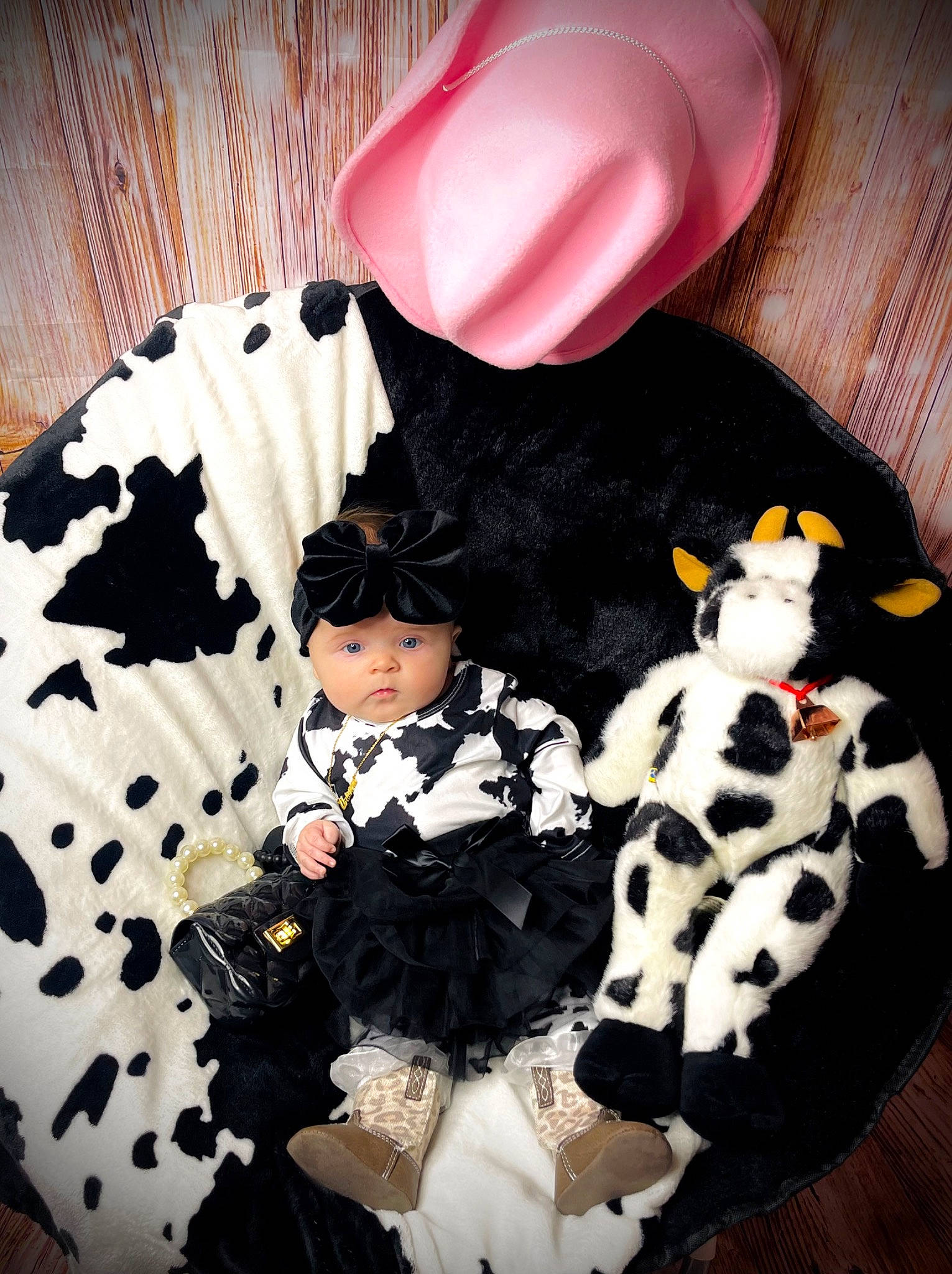 Arianna is registered to the contest to win money with this photo: baby_toddler_clothing, black_hair, cap, carmine, costume, costume_hat, fashion_accessory, font, fur, hairstyle, hat, headgear, headwear, pattern, person, pink, sitting, sleeve, stuffed_toy, thigh