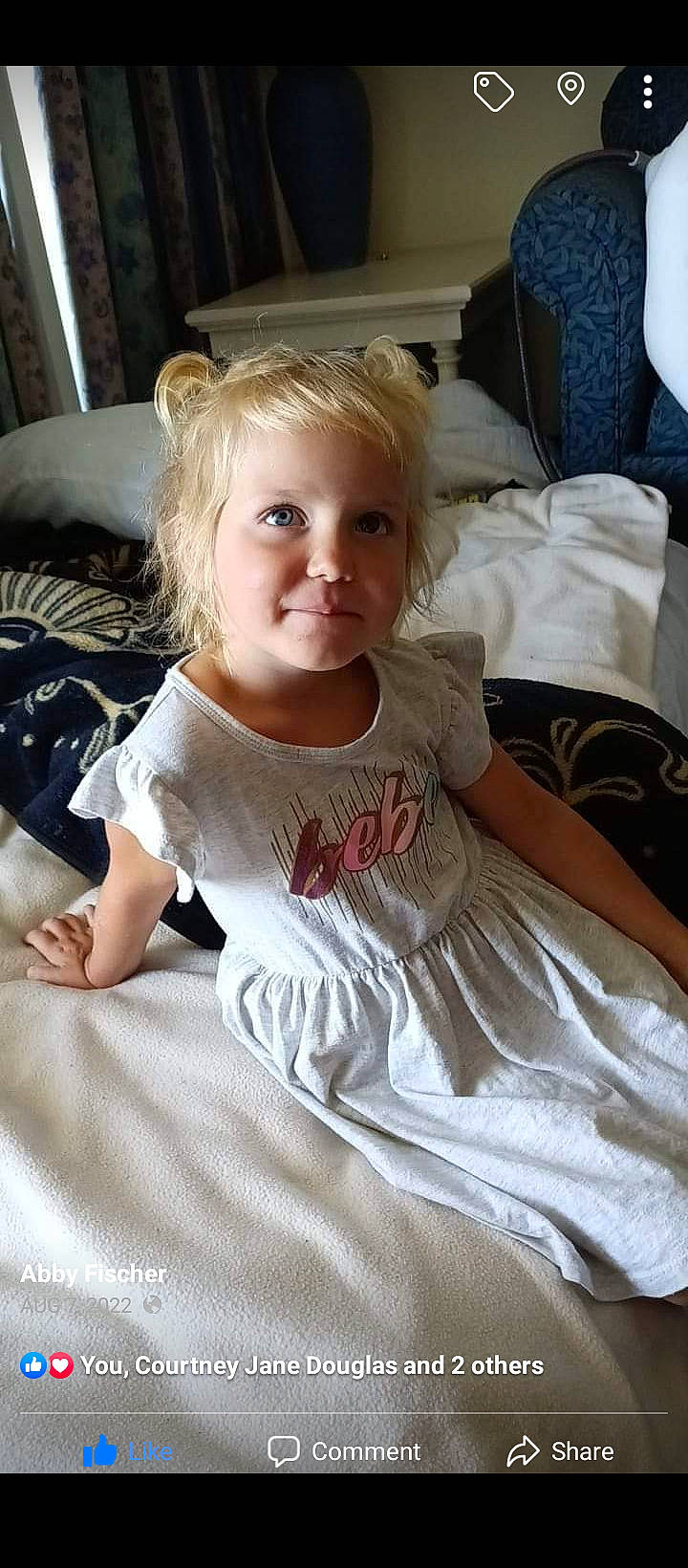 Kylie is registered to the contest to win money with this photo: baby_toddler_clothing, blond, cheek, child, chin, comfort, day_dress, dress, fun, hair, hairstyle, happy, one_piece_garment, person, shoulder, sitting, sleeve, smile, t_shirt, textile