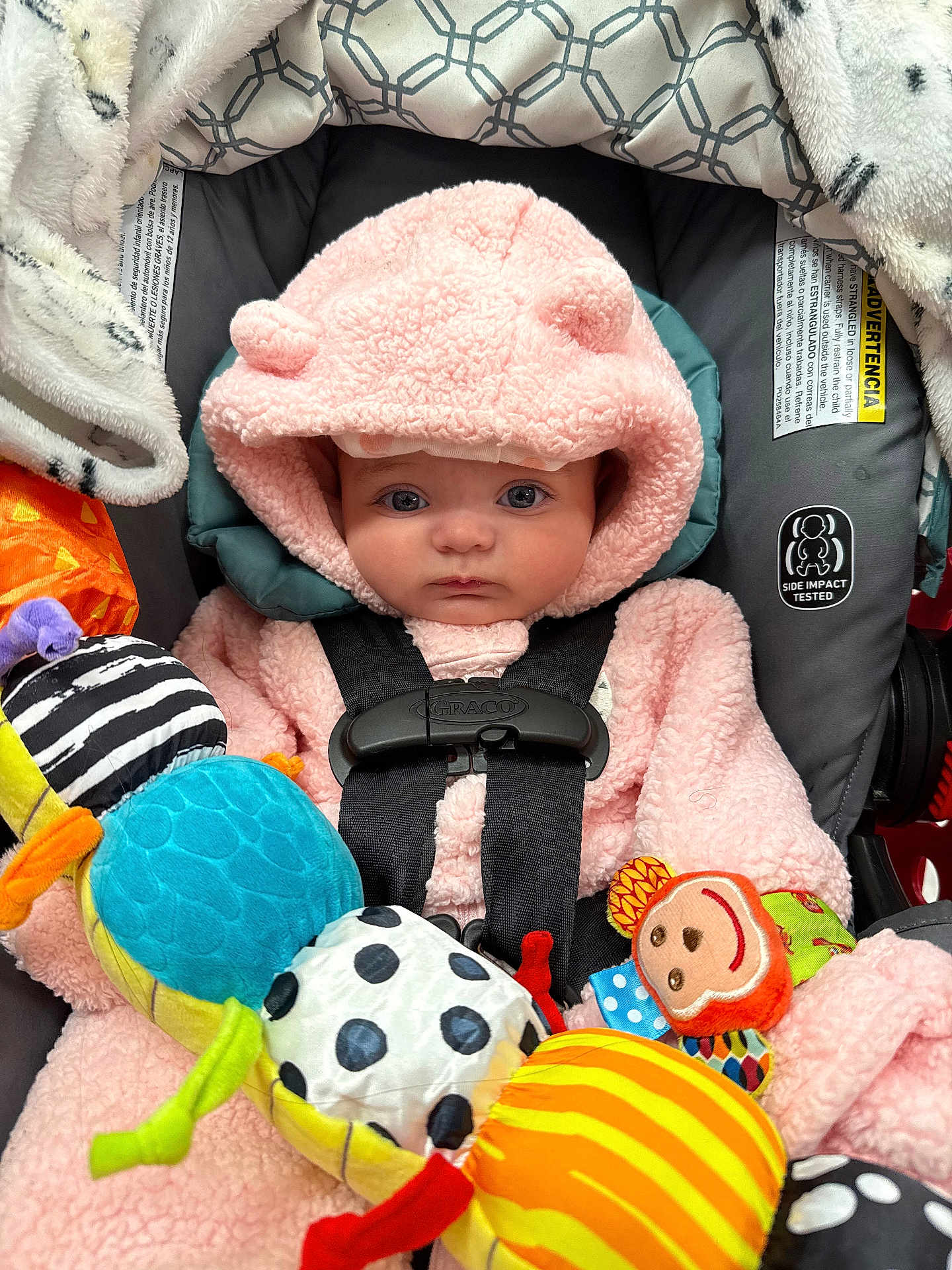 Gianna joined the competition — help win amazing prizes! baby, child, pink_hoodie, car_seat, toy, colorful, caterpillar_toy, plush, cute, infant, straps, blanket, face, eyes, clothing, indoor, soft, comfort, safety, hood