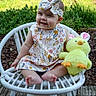 baby, child, girl, outdoor, chair, wicker_chair, stuffed_animal, toy, yellow, dress, headband, flower_pattern, smile, happy, grass, nature, wooden_floor, cute, sitting, portrait