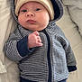 Alfie joined the competition — help win amazing prizes! baby, infant, striped_clothing, hoodie, hat, blanket, bed, lying_down, cute, child, person, soft, warm, indoor, casual, portrait, young, sleepwear, comfort, rest
