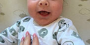 Alfie joined the competition — help win amazing prizes! baby, smiling, hand, onesie, bear_pattern, blue_eyes, infant, blanket, cloud_pattern, cute, happy, portrait, child, person, skin, nail_polish, toddler, lying_down, closeup, indoors