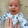 baby, smiling, hand, onesie, bear_pattern, blue_eyes, infant, blanket, cloud_pattern, cute, happy, portrait, child, person, skin, nail_polish, toddler, lying_down, closeup, indoors