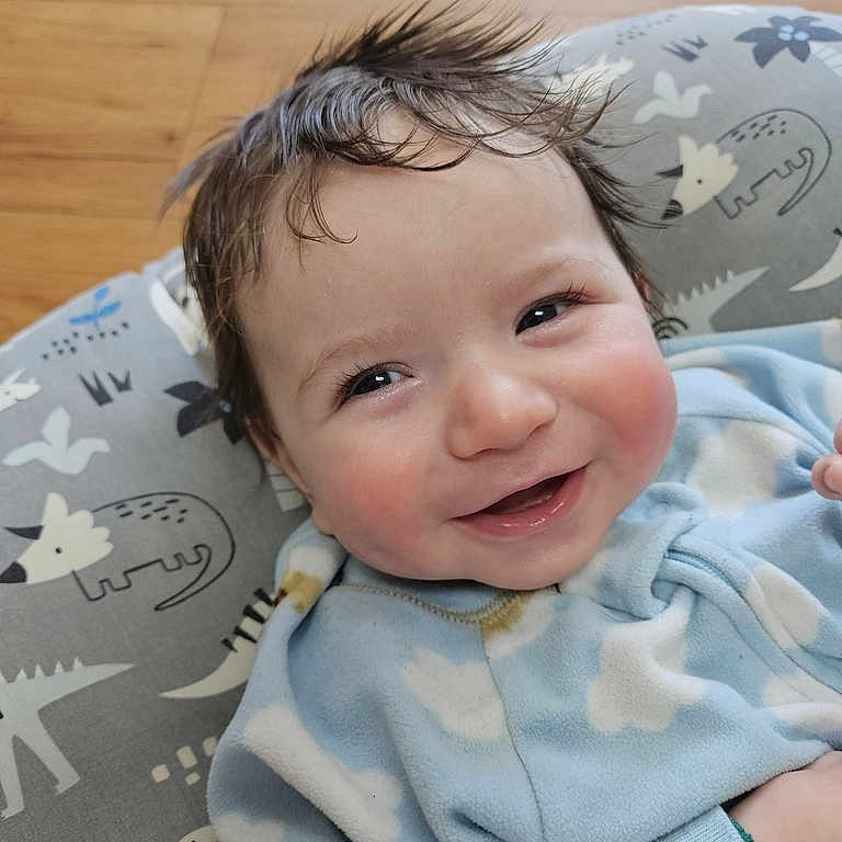 Hunter joined the competition — help win amazing prizes! baby, blanket, bodypart, couch, cushion, face, furniture, happy, head, homedecor, indoors, laughing, mouth, newborn, person, photography, portrait, quilt, smile, teeth