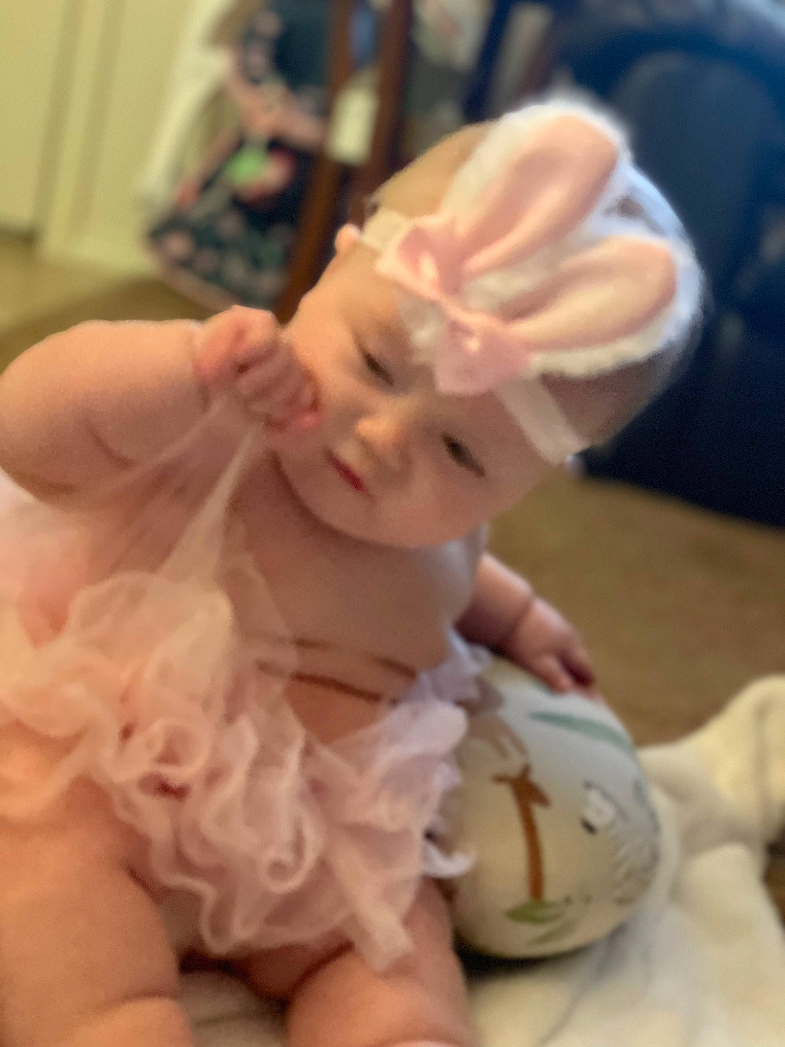 Ellen is registered to the contest to win money with this photo: baby, baby_toddler_clothing, cheek, child, comfort, ear, fashion_accessory, flesh, gesture, hair_accessory, happy, headgear, headpiece, headwear, human_body, mouth, nail, peach, person, sitting