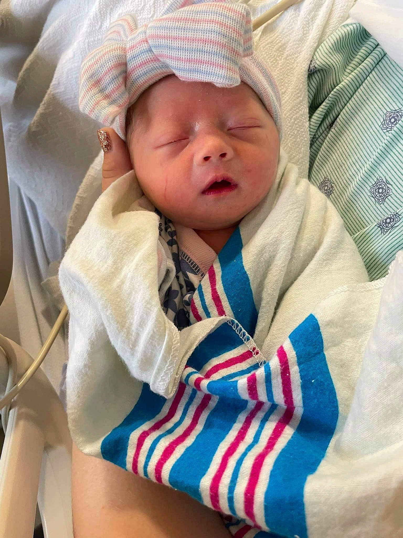 Ellen is registered to the contest to win money with this photo: baby, baby_products, baby_safety, baby_sleeping, baby_toddler_clothing, cap, cheek, child, comfort, face, facial_expression, finger, headwear, human, linens, pattern, person, sitting, skin, sleeve