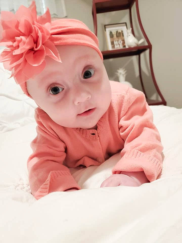 Athena is registered to the contest to win money with this photo: baby, baby_toddler_clothing, beauty, cheek, child, eye, face, hair_accessory, head, headgear, headwear, lip, nose, outerwear, person, pink, portrait_photography, skin, smile, toddler