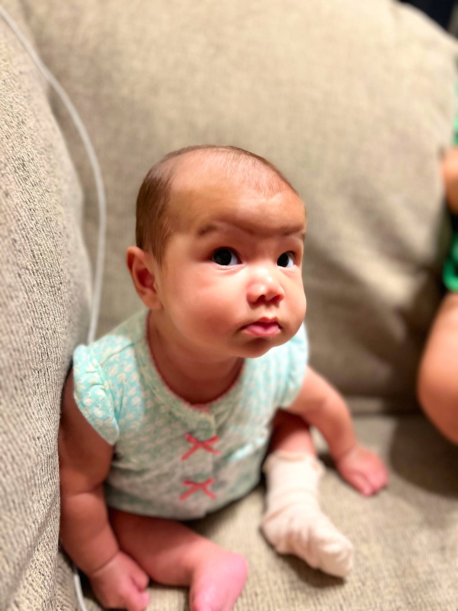 Emilia joined the competition — help win amazing prizes! baby, baby_toddler_clothing, cheek, child, chin, comfort, floor, flooring, fun, green, happy, hardwood, head, mouth, nose, person, sitting, skin, sleeve, toddler