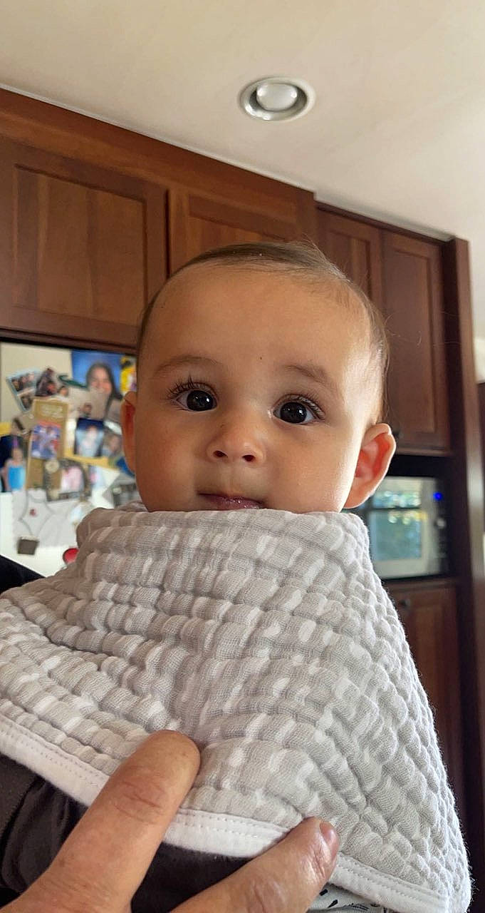 Beaux joined the competition — help win amazing prizes! baby, baby_toddler_clothing, blurred, carmine, cheek, chin, comfort, finger, floor, flooring, foot, gesture, human_leg, linens, mouth, nail, person, sitting, thumb, toddler