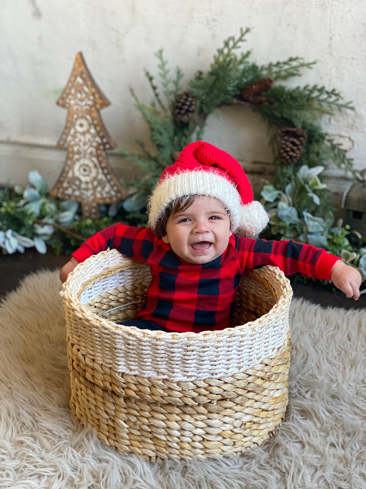 Wren is registered to the contest to win money with this photo: baby, baby_toddler_clothing, basket, christmas_decoration, christmas_ornament, comfort, grass, happy, headgear, headwear, holiday, outerwear, people_in_nature, person, plant, smile, storage_basket, toddler, winter, wood